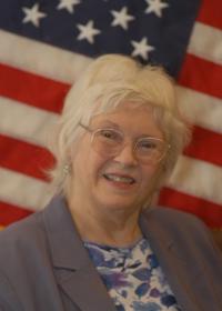photo of Ann Young in front of an American flag